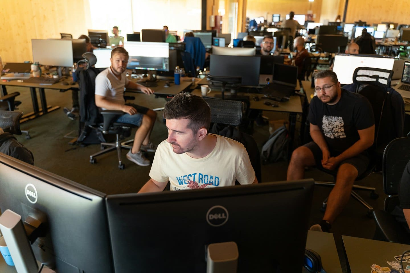 IT professionals collaborating at their desks in a modern office.